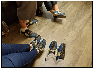 Friends wearing bowling shoes